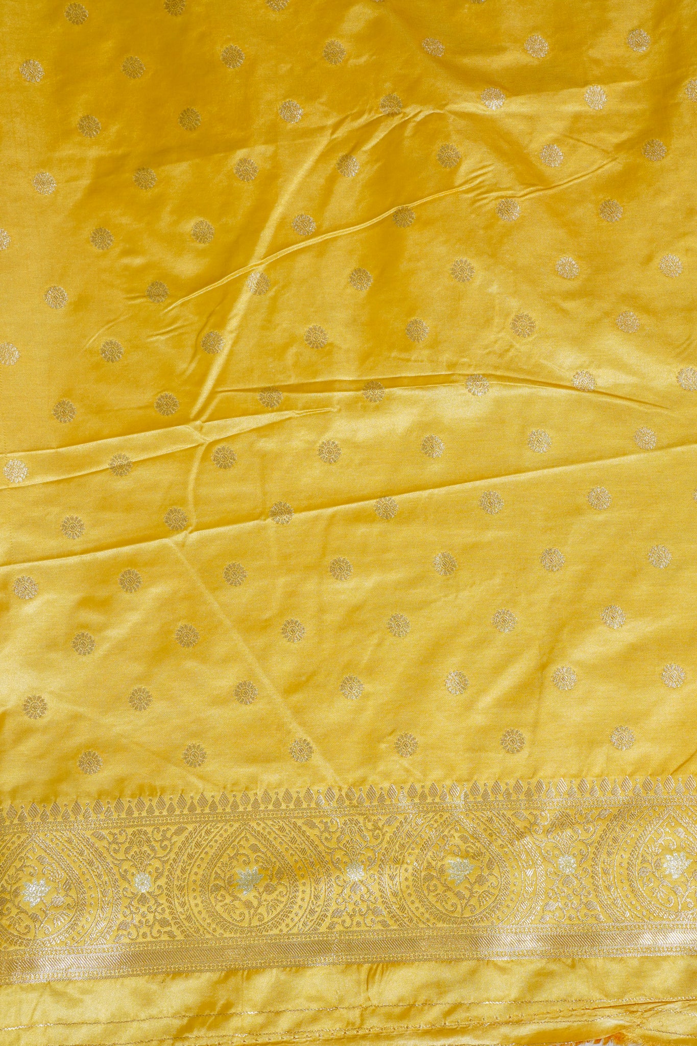 Yellow fabric with gold patterns and border