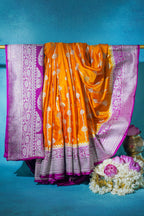 Orange saree with purple border on a blue background