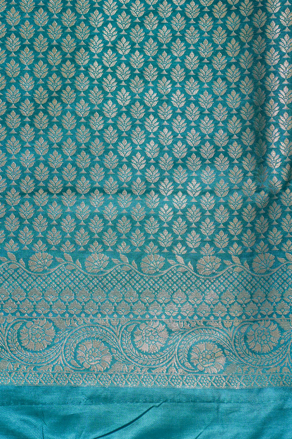 Teal fabric with white floral pattern