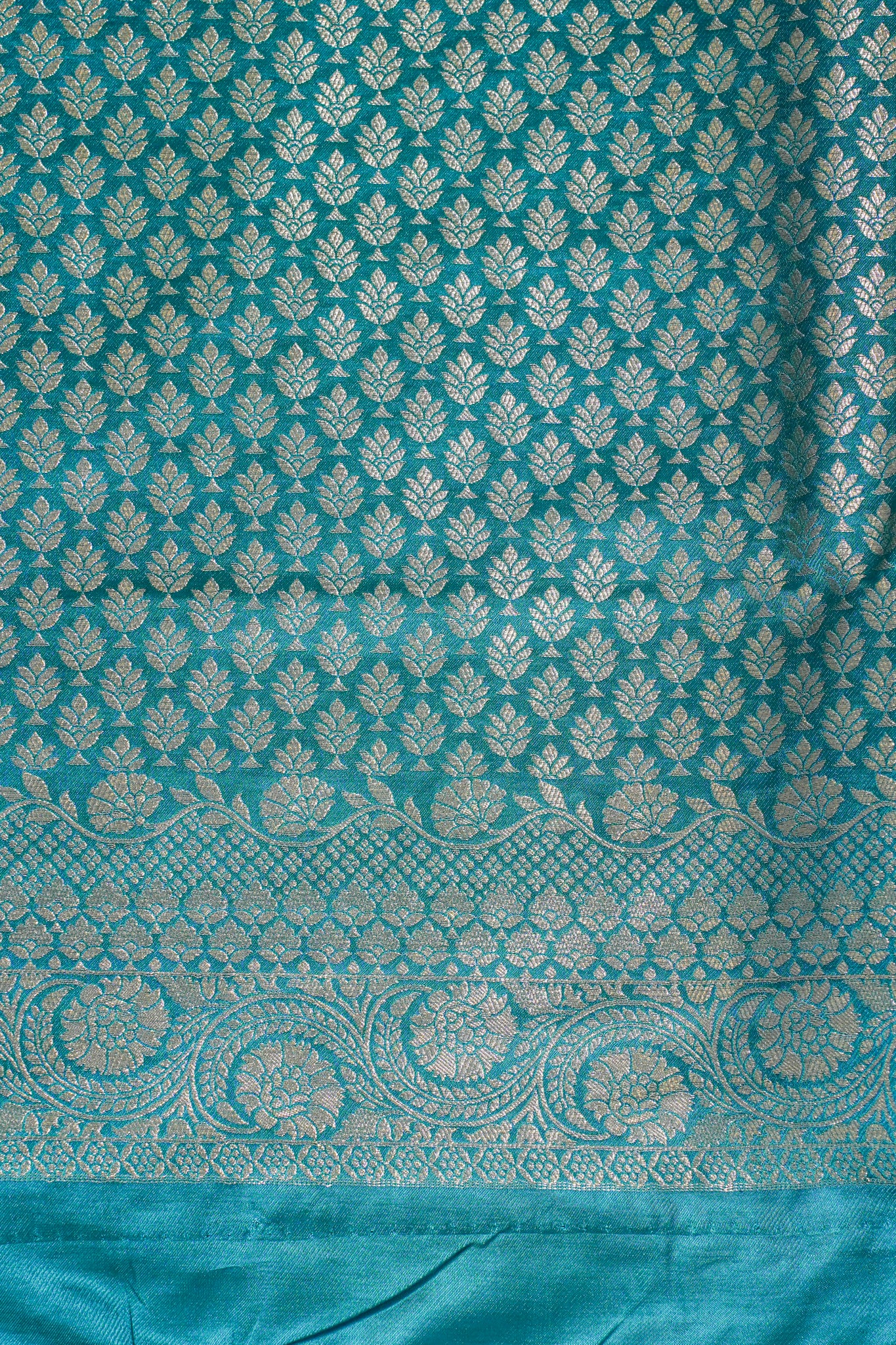 Teal fabric with white floral pattern