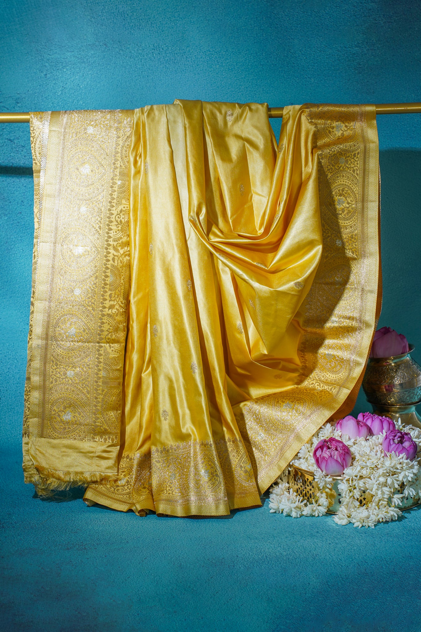 Yellow saree with intricate patterns on a blue background