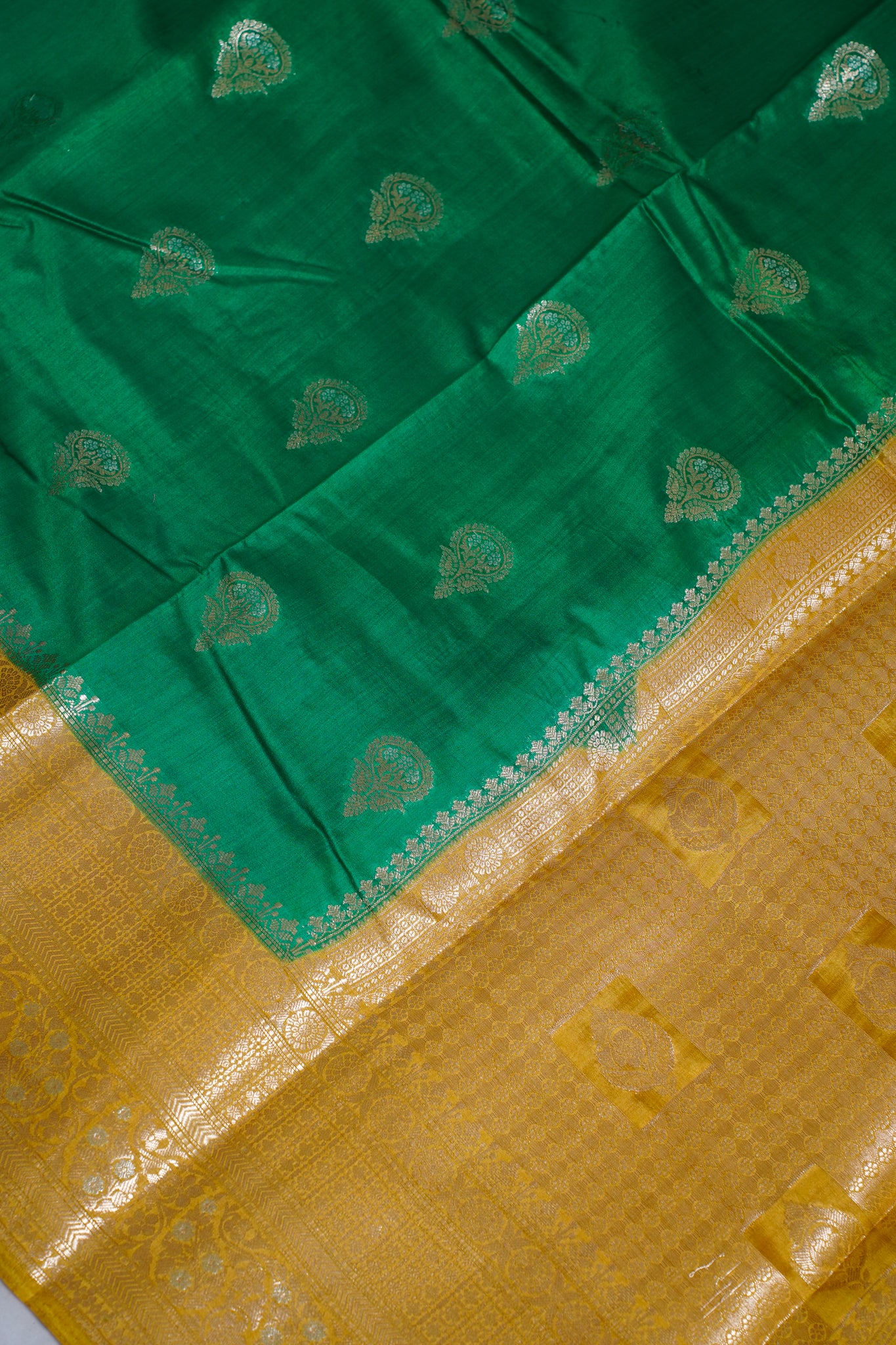 Green and yellow fabric with intricate patterns