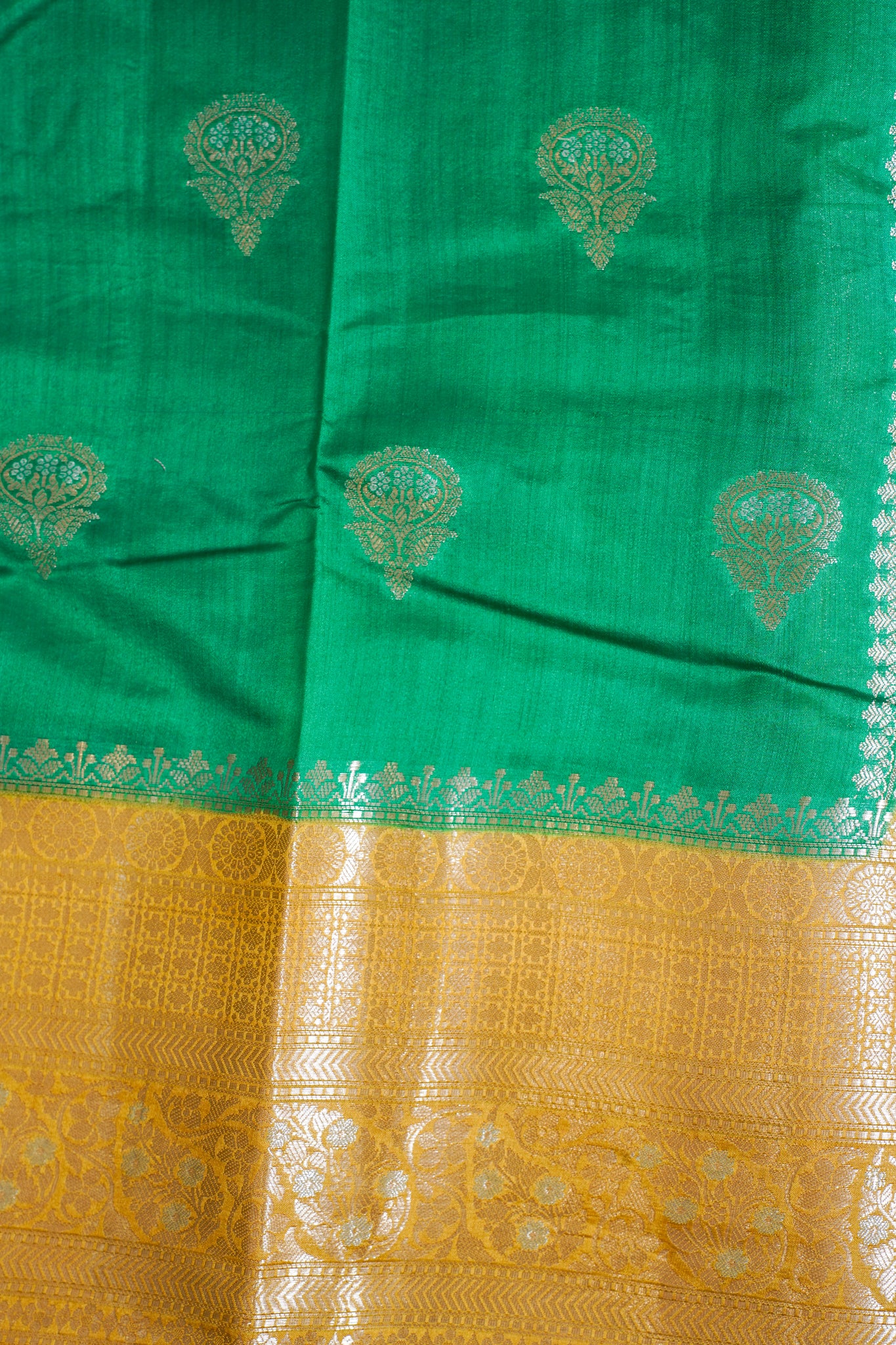 Green and yellow fabric with intricate patterns