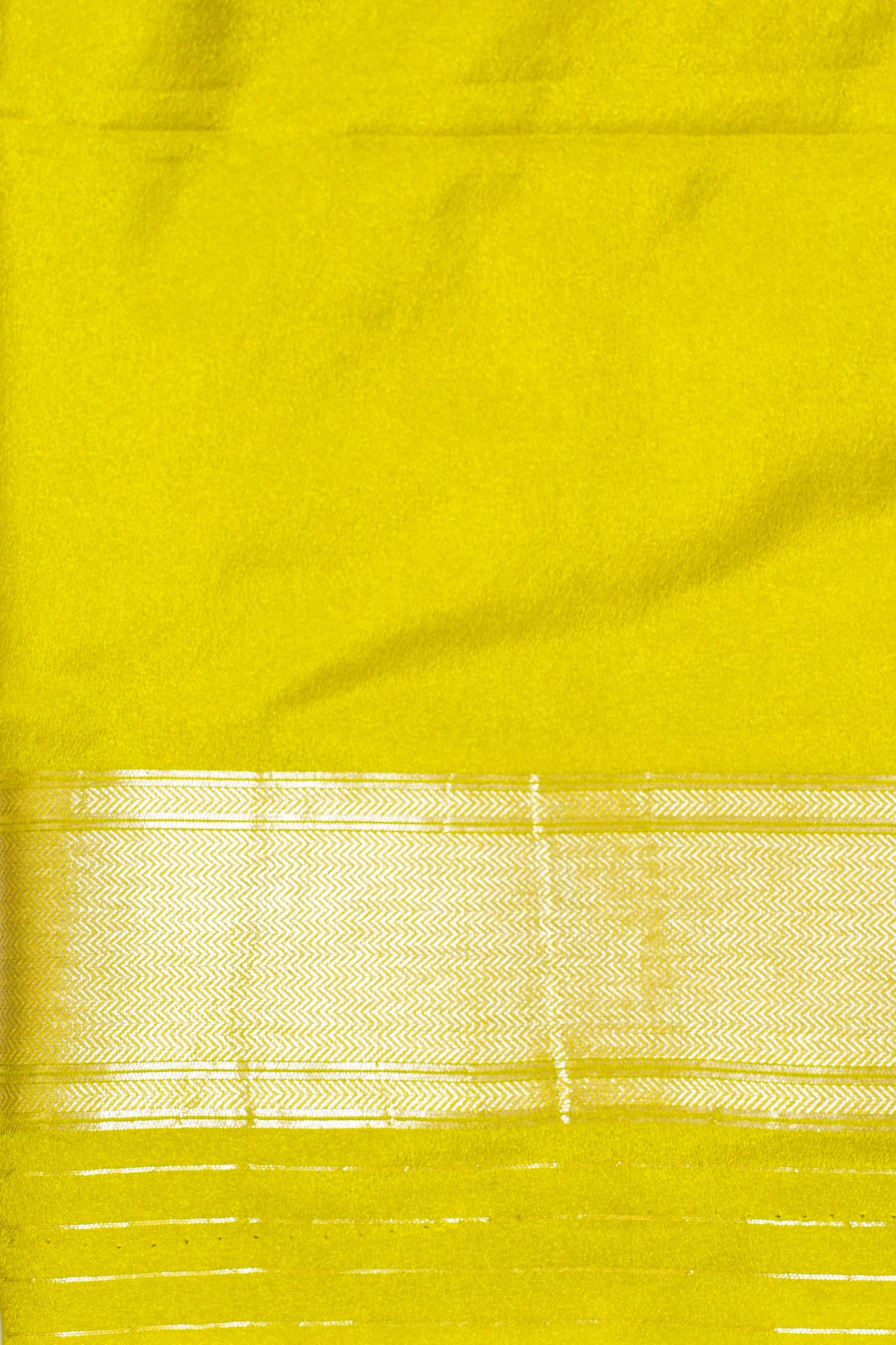 Close-up of a yellow fabric with a subtle pattern