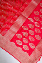 Red fabric with white floral patterns on a white background