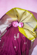 Purple saree with gold border and pink flowers on a pink background