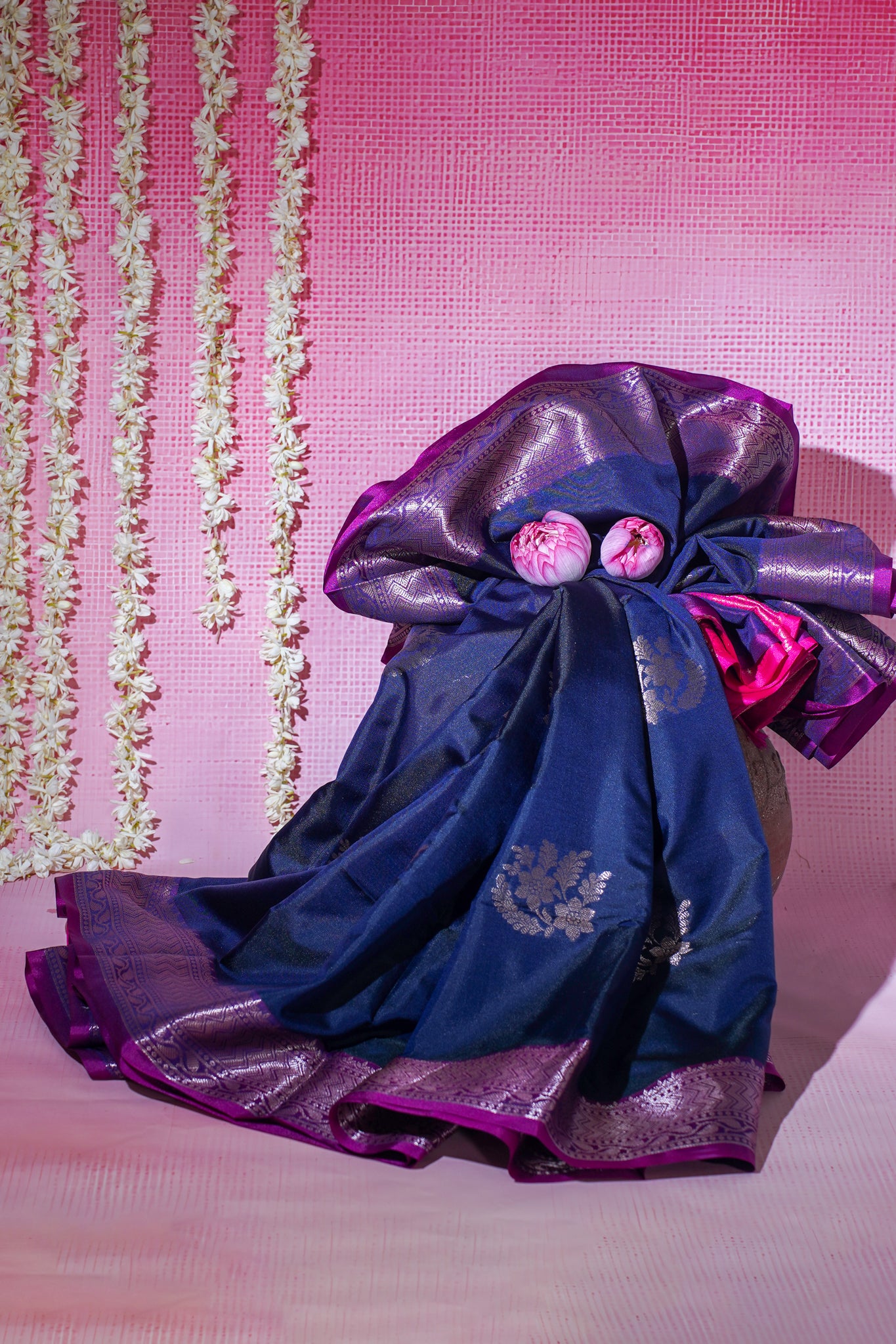 Traditional blue and purple colors saree on a pink background