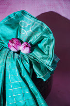 Turquoise fabric with pink flowers on a purple background