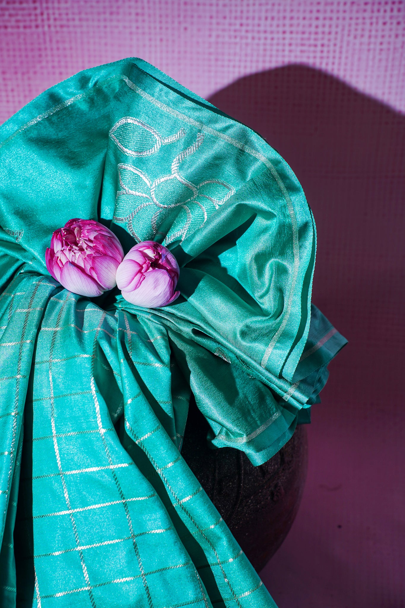 Turquoise fabric with pink flowers on a purple background