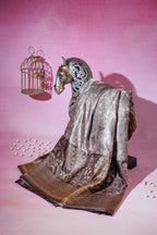 Decorative brown silk saree with horse sculpture with a birdcage on a pink background