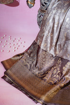 Silk saree with gold and silver patterns on a pink background