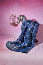 Blue floral-patterned fabric draped over a horse head sculpture on a pink background
