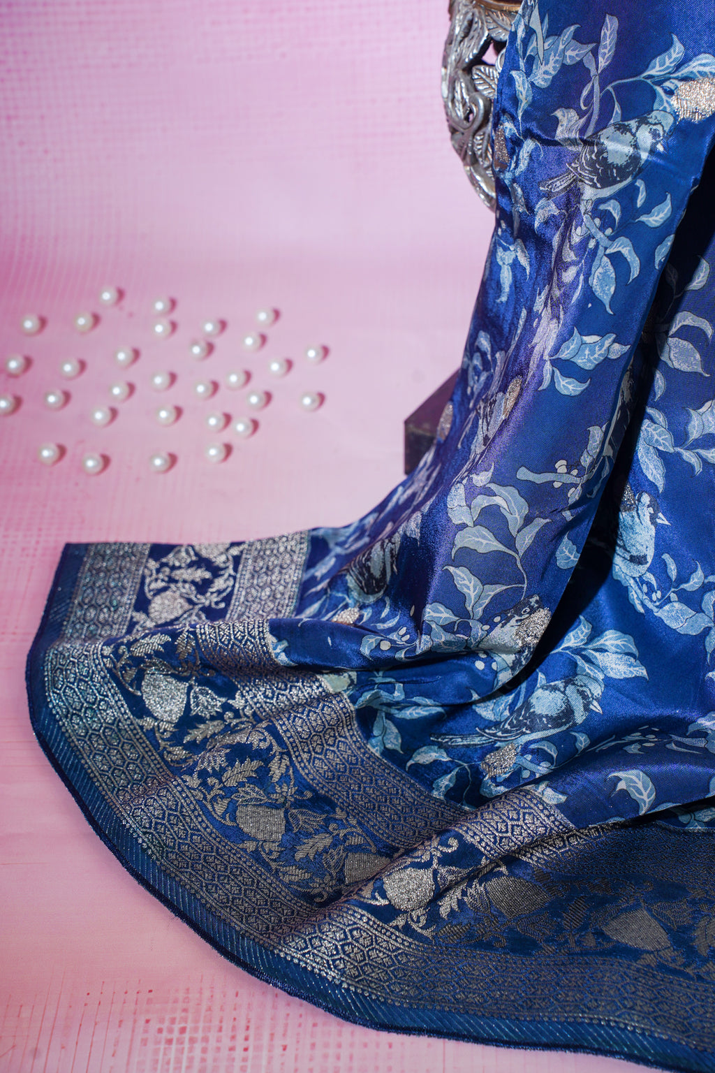Blue saree with silver patterns on a pink background