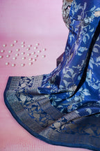 Blue saree with silver patterns on a pink background