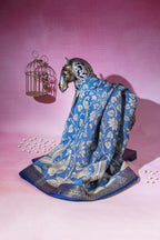 Decorative horse figurine with a blue floral-patterned cloth on a pink background